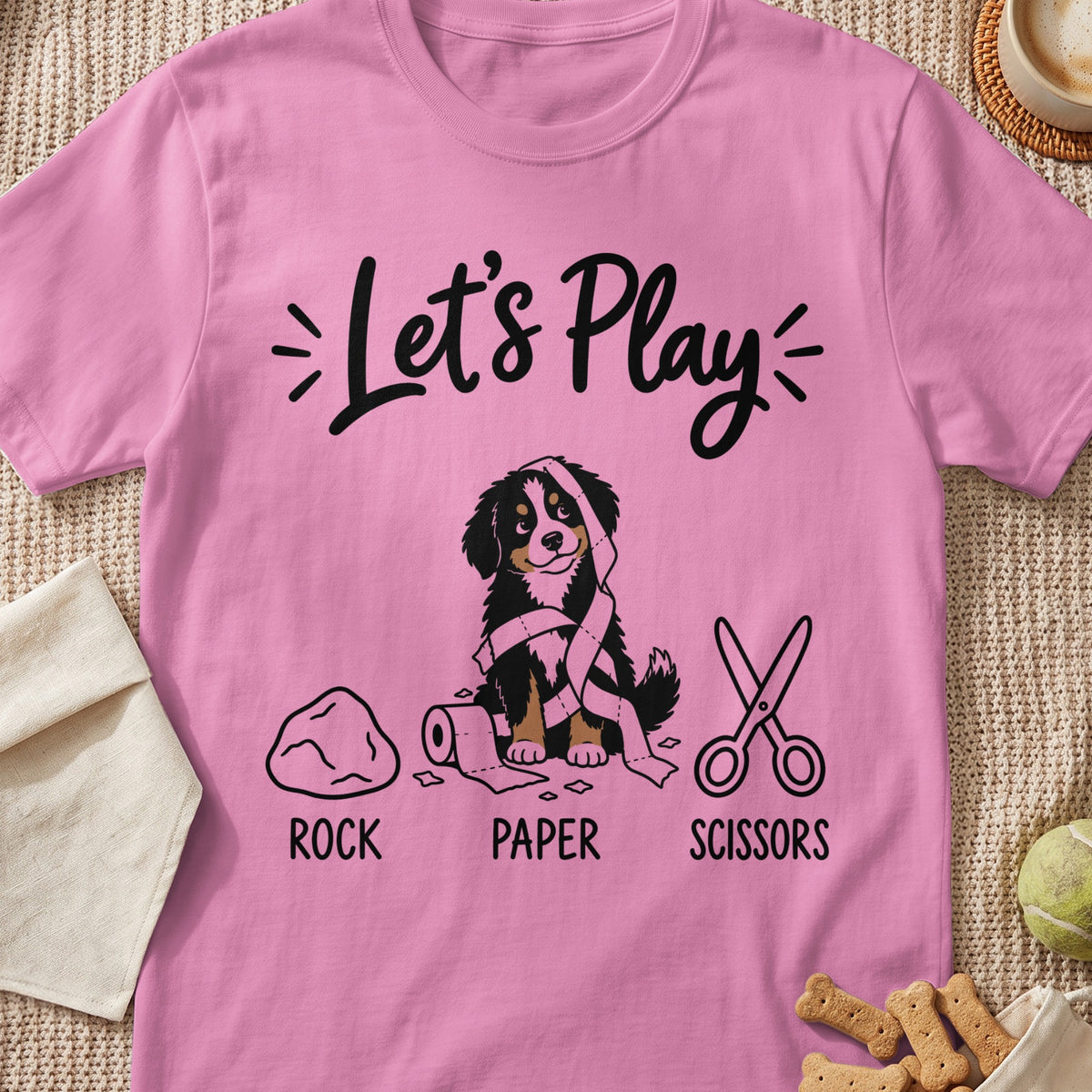 Pink t-shirt with "Let's Play" and dog with toilet paper, rock, paper, scissors.