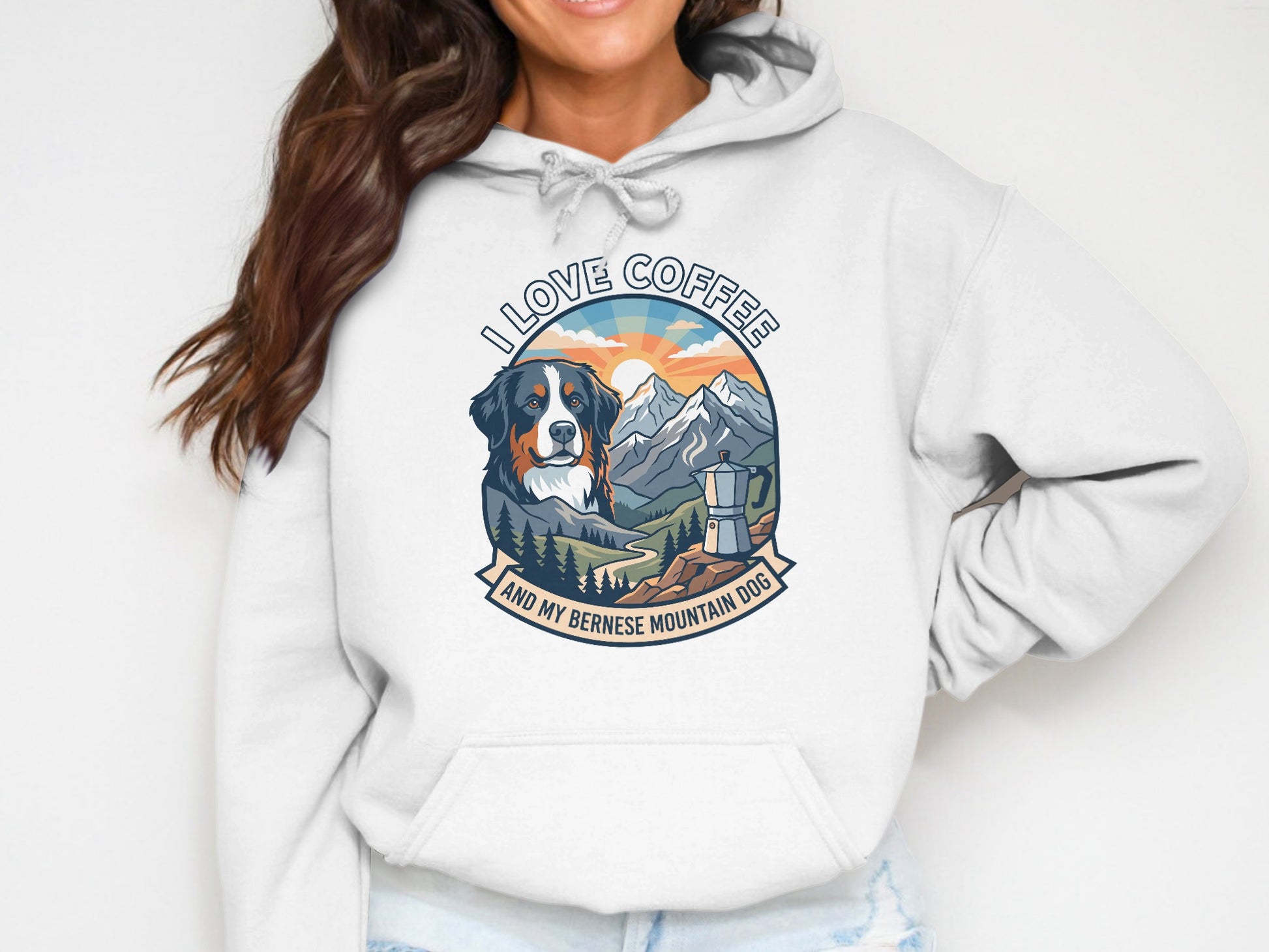 White hoodie with graphic of Bernese Mountain Dog, coffee maker, and mountains, text reads "I LOVE COFFEE AND MY BERNESE MOUNTAIN DOG".