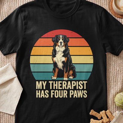 Black t-shirt with vintage sunset graphic and text "MY THERAPIST HAS FOUR PAWS".