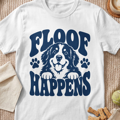 White t-shirt with navy graphic of a smiling dog and text "FLOOF HAPPENS".