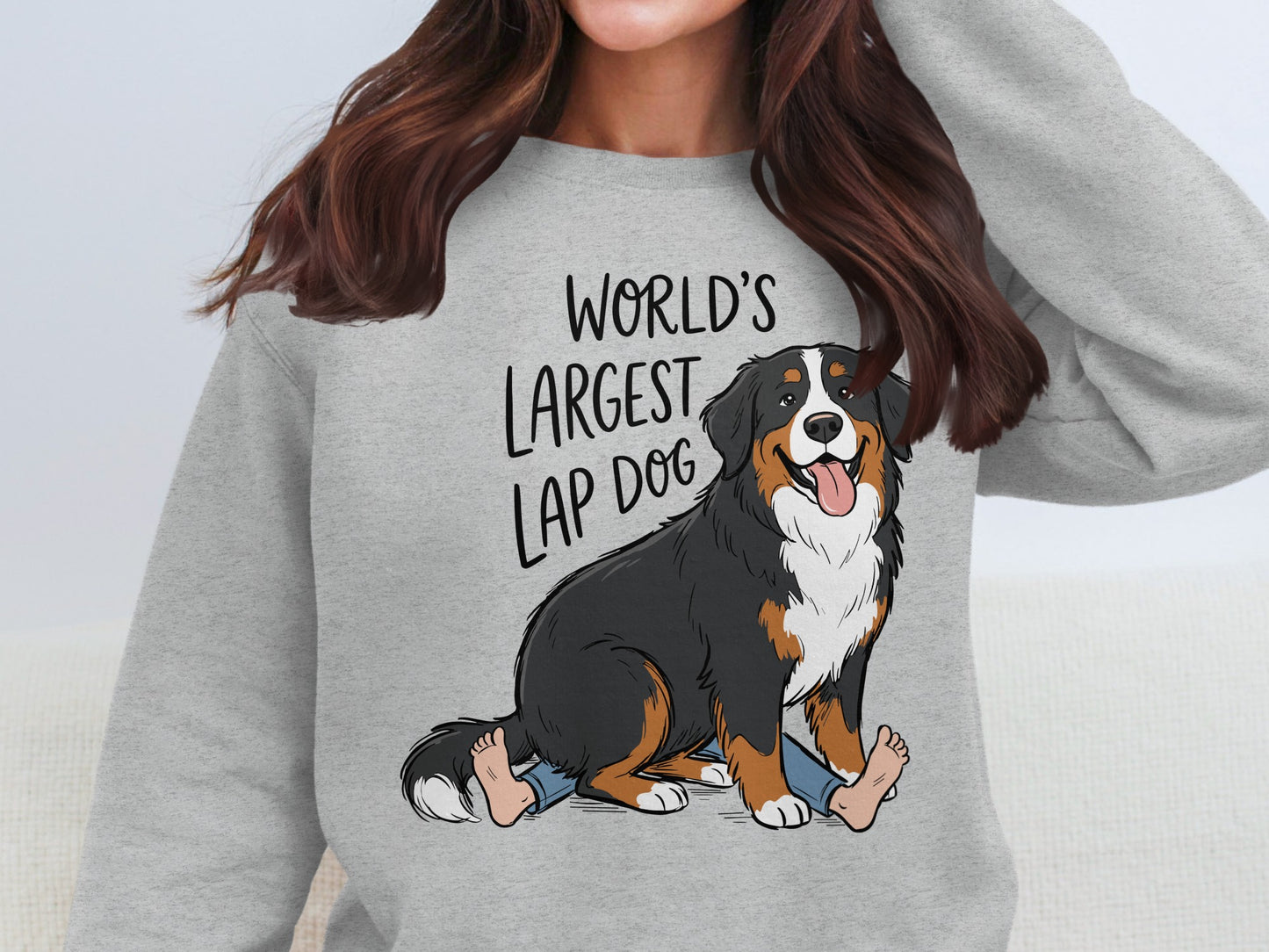 Grey sweatshirt with "World's Largest Lap Dog" text and cartoon Bernese Mountain Dog.