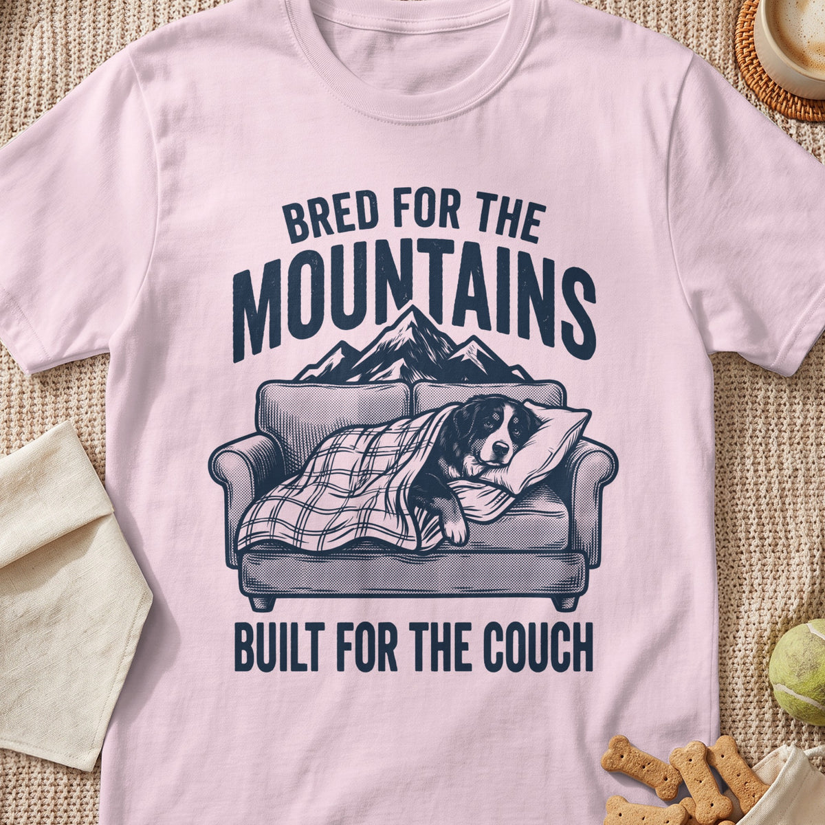 Bernese Mountain Dog on couch with plaid blanket, "Bred for the Mountains, Built for the Couch" text.