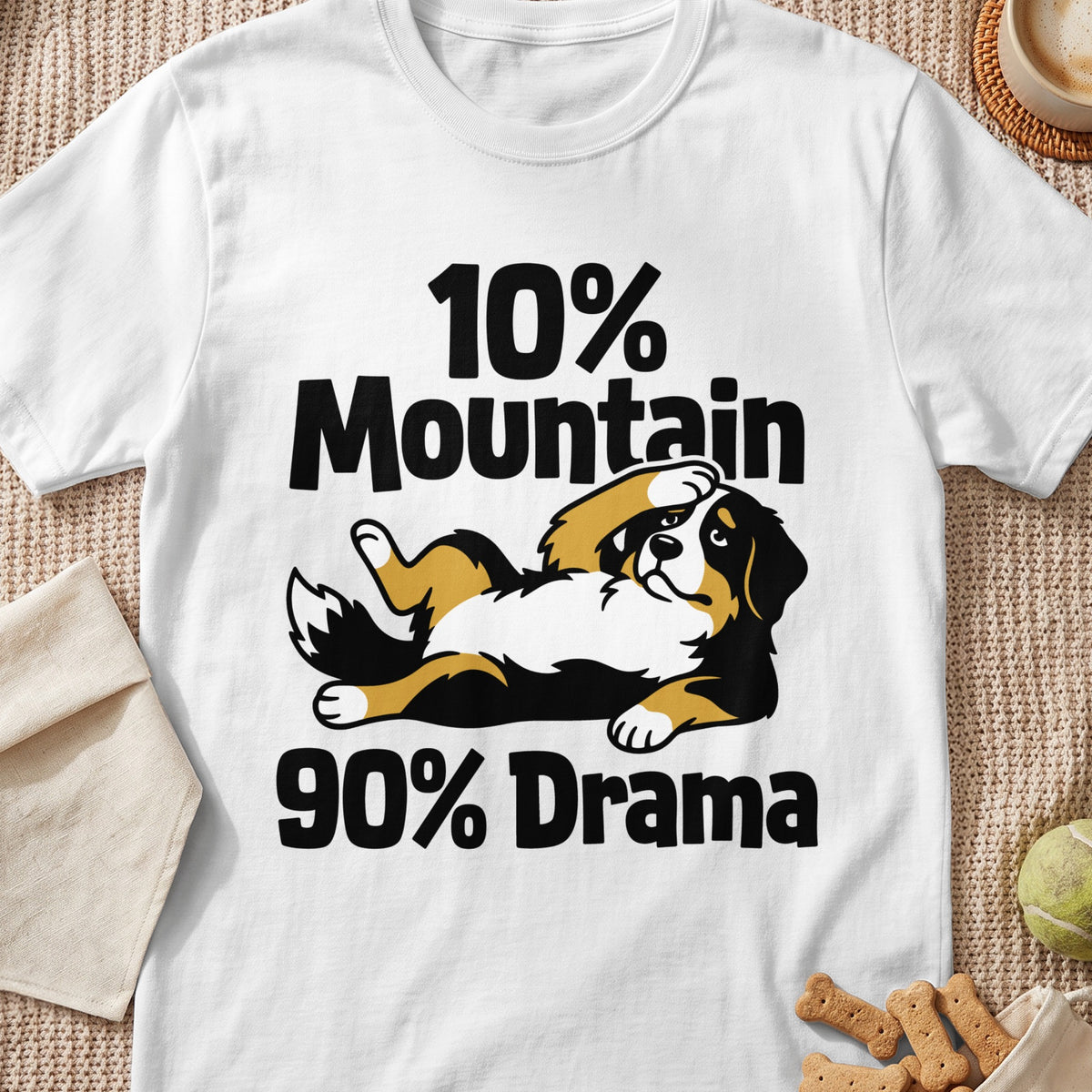 White t-shirt featuring an illustration of a Bernese Mountain Dog lying down with text reading "10% Mountain 90% Drama".