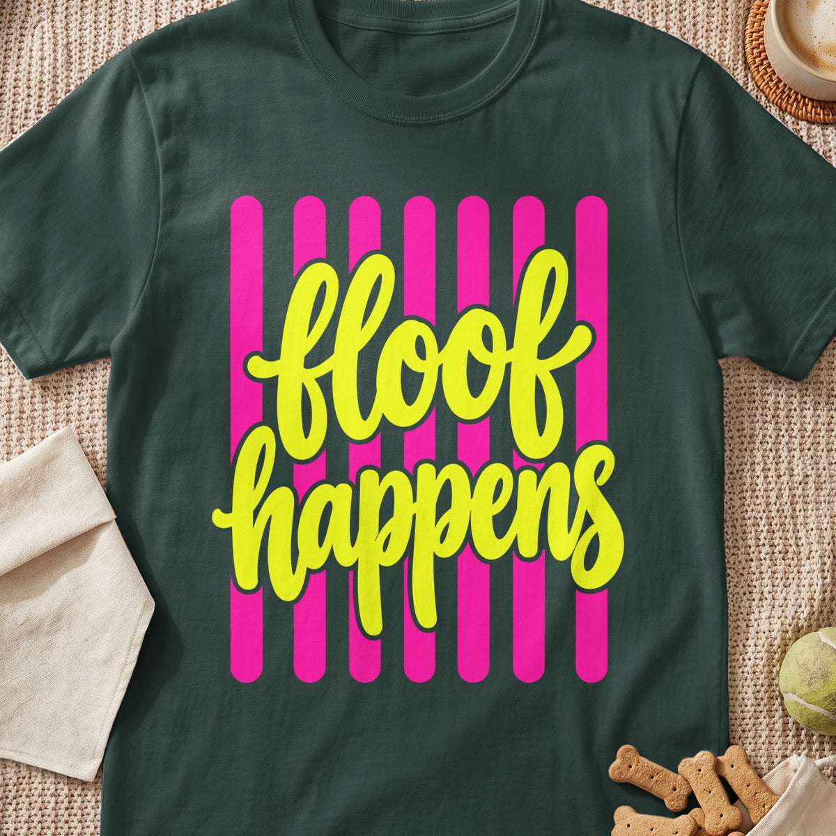 Dark green t-shirt with yellow text "floof happens" on pink vertical stripes.