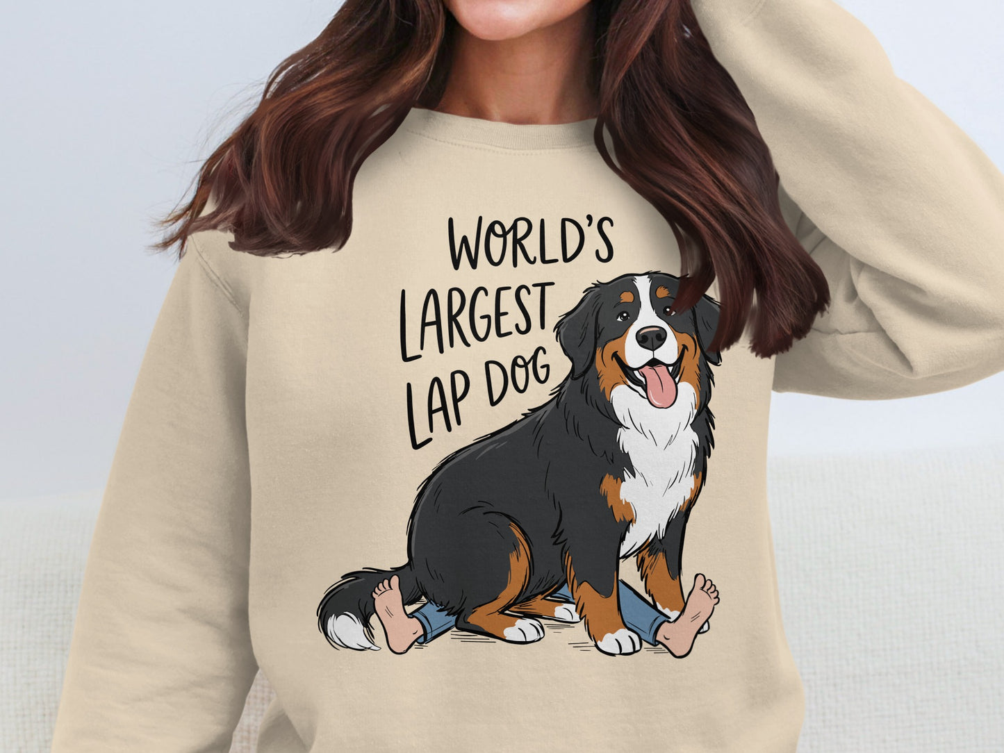 Bernese Mountain Dog sitting on legs, text reads "World's Largest Lap Dog".
