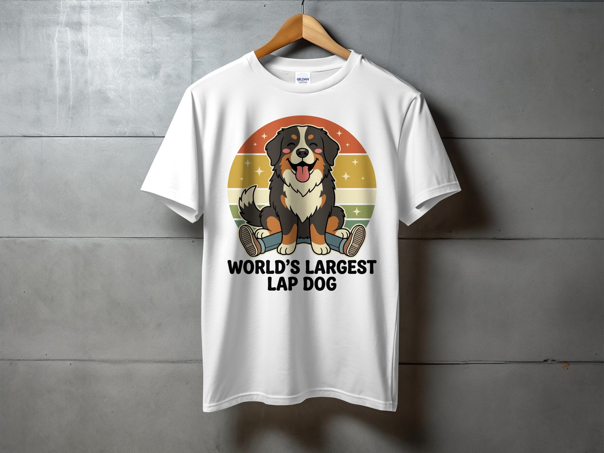 White t-shirt with a cartoon Bernese Mountain Dog and the text "World's Largest Lap Dog."