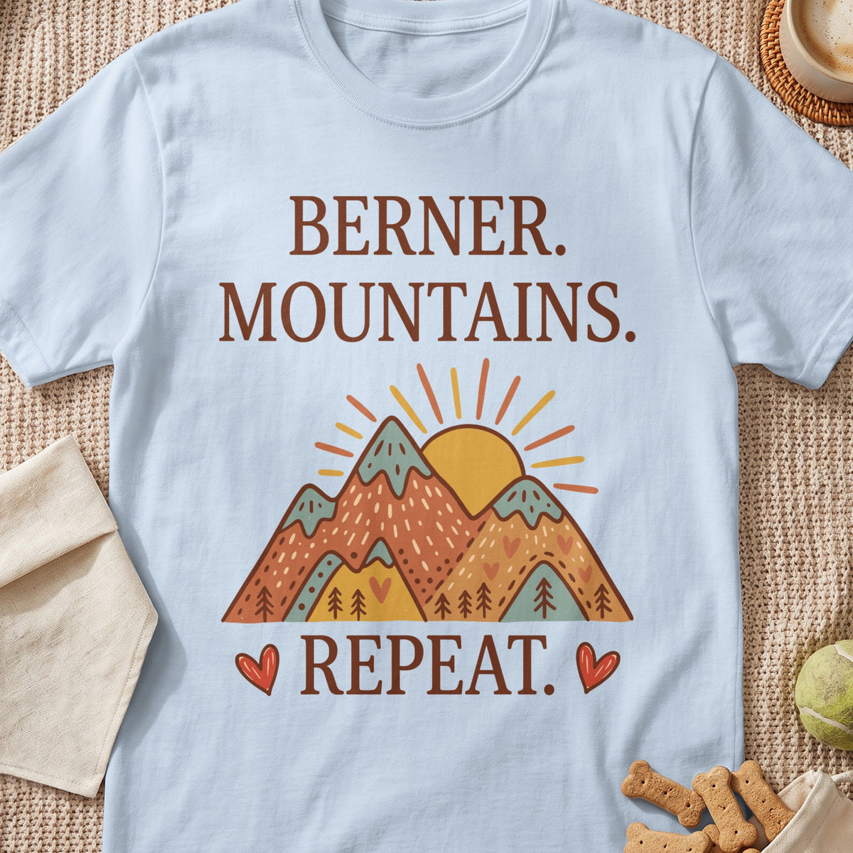 Light blue t-shirt with "Berner. Mountains. Repeat." text and mountain graphic.