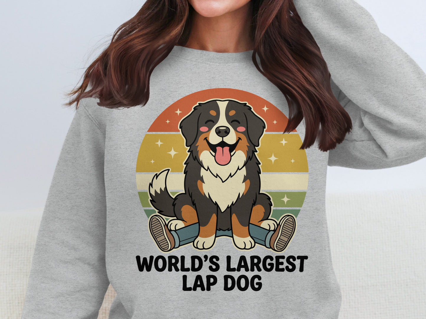 Bernese Mountain Dog with "World's Largest Lap Dog" text on a grey sweatshirt.