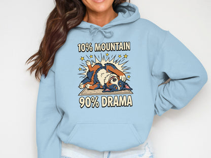 Light blue hoodie with cartoon Bernese Mountain Dog and text "10% Mountain 90% Drama".