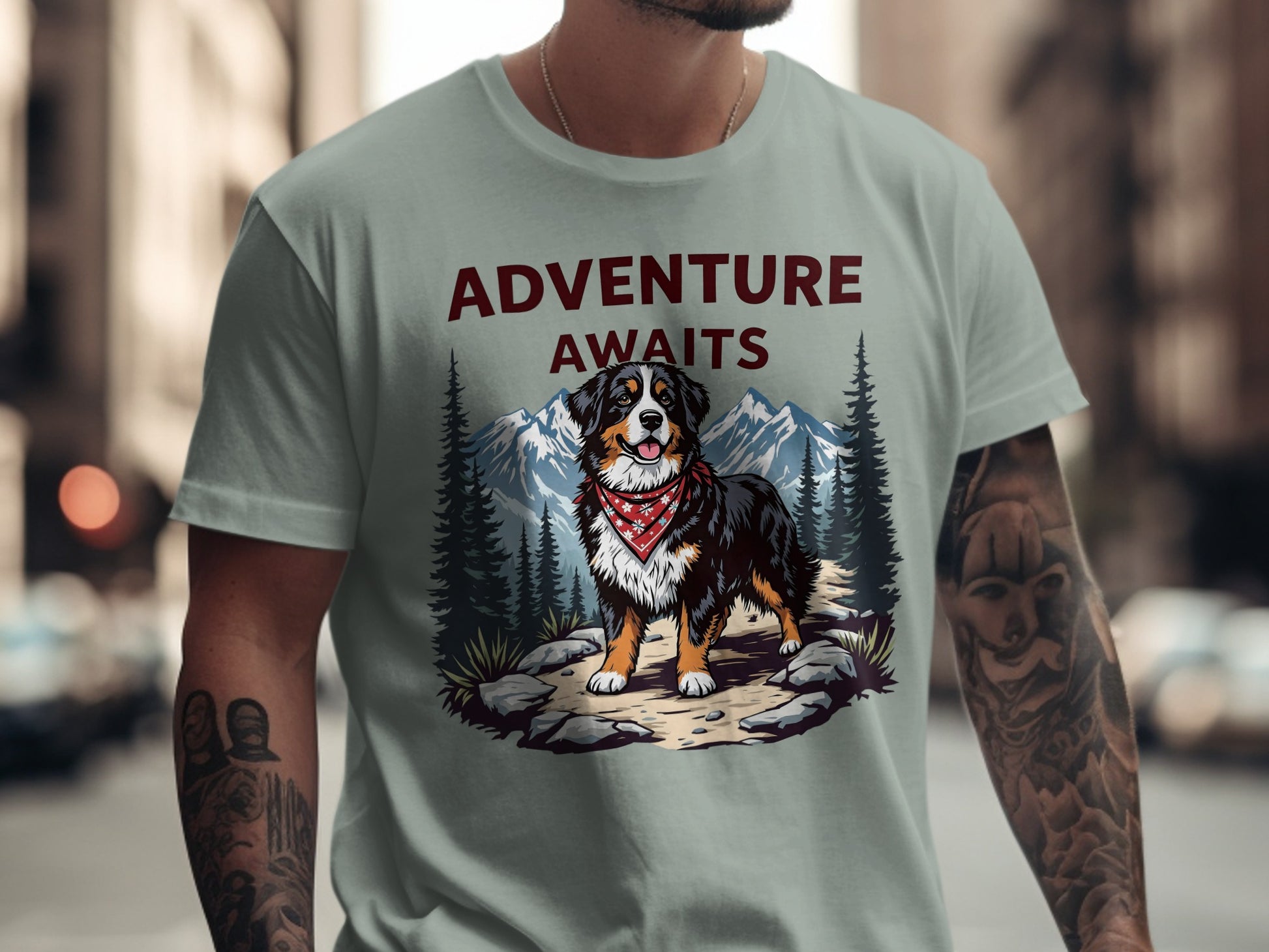 Bernese mountain dog graphic with "ADVENTURE AWAITS" text on a light green shirt.