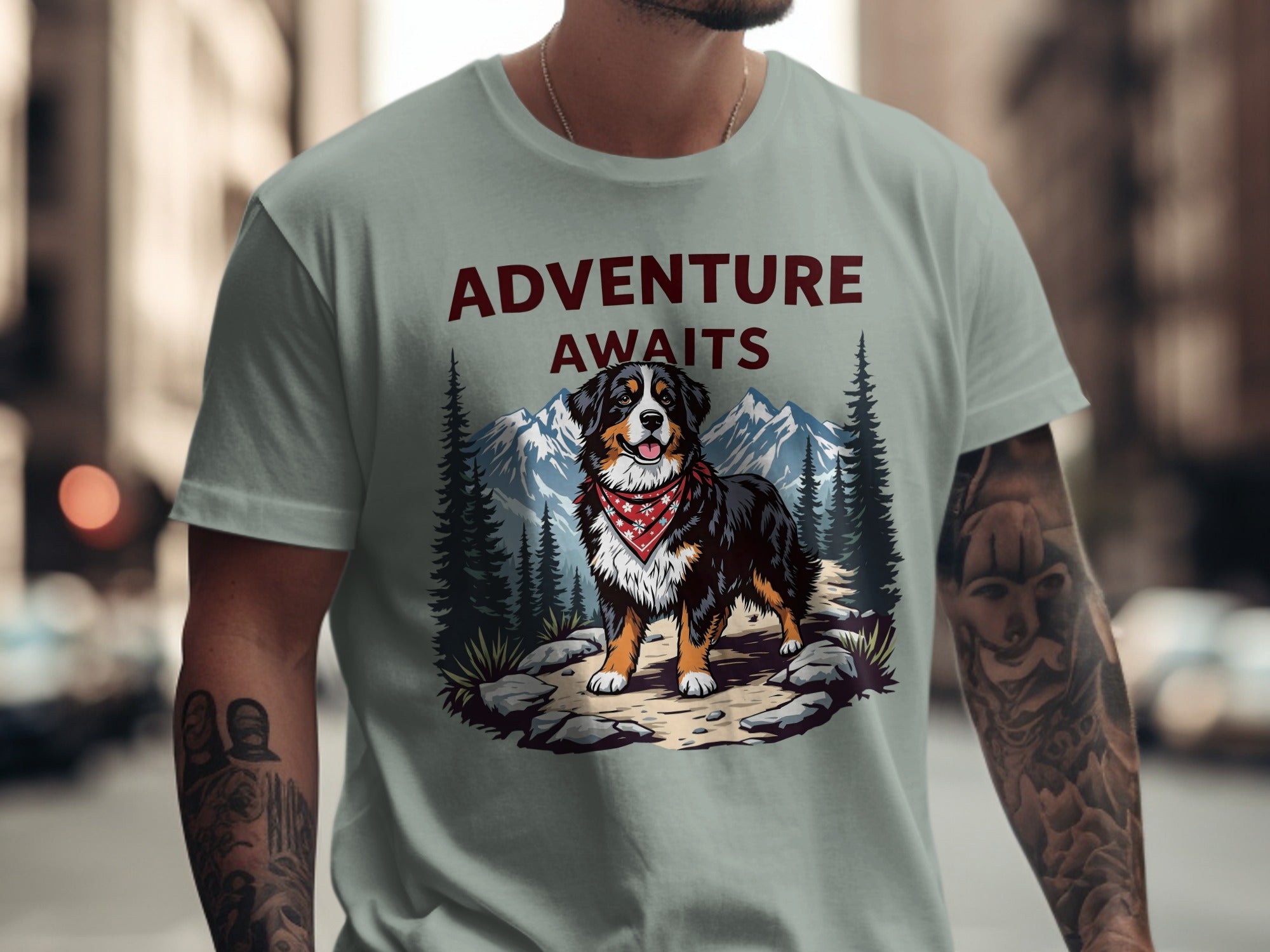 Bernese mountain dog graphic with "ADVENTURE AWAITS" text on a light green shirt.