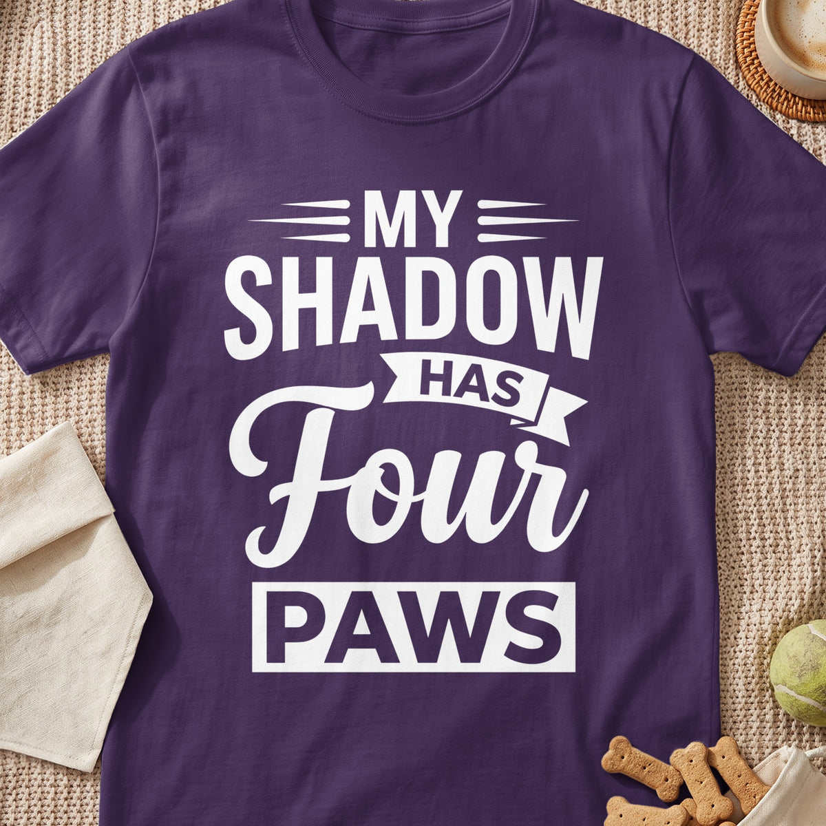 Purple t-shirt with white text: "MY SHADOW HAS FOUR PAWS".