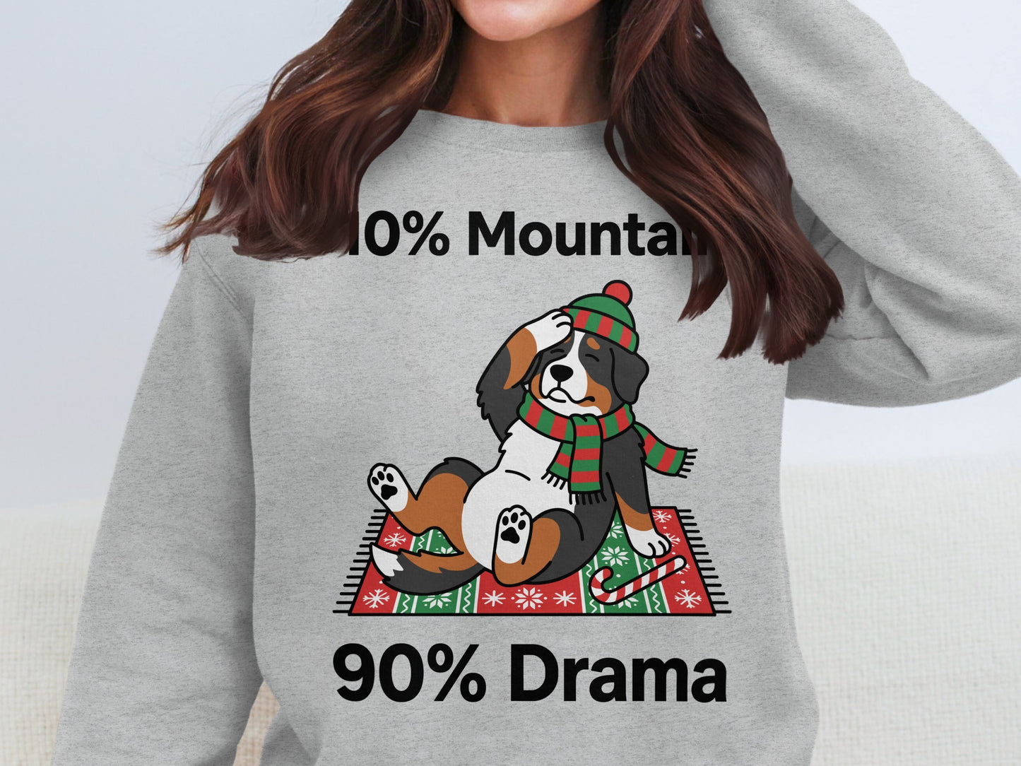 Bernese Mountain Dog wearing festive scarf and hat, with text "10% Mountain 90% Drama".