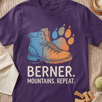 Purple t-shirt with a hiking boot and paw print graphic and text "BERNER. MOUNTAINS. REPEAT."