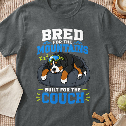 Bernese Mountain Dog sleeping on a pillow wearing goggles, "Bred for the Mountains, Built for the Couch" text.