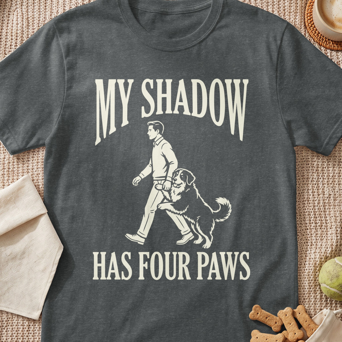 Dark grey t-shirt with cream text "MY SHADOW HAS FOUR PAWS" and graphic.