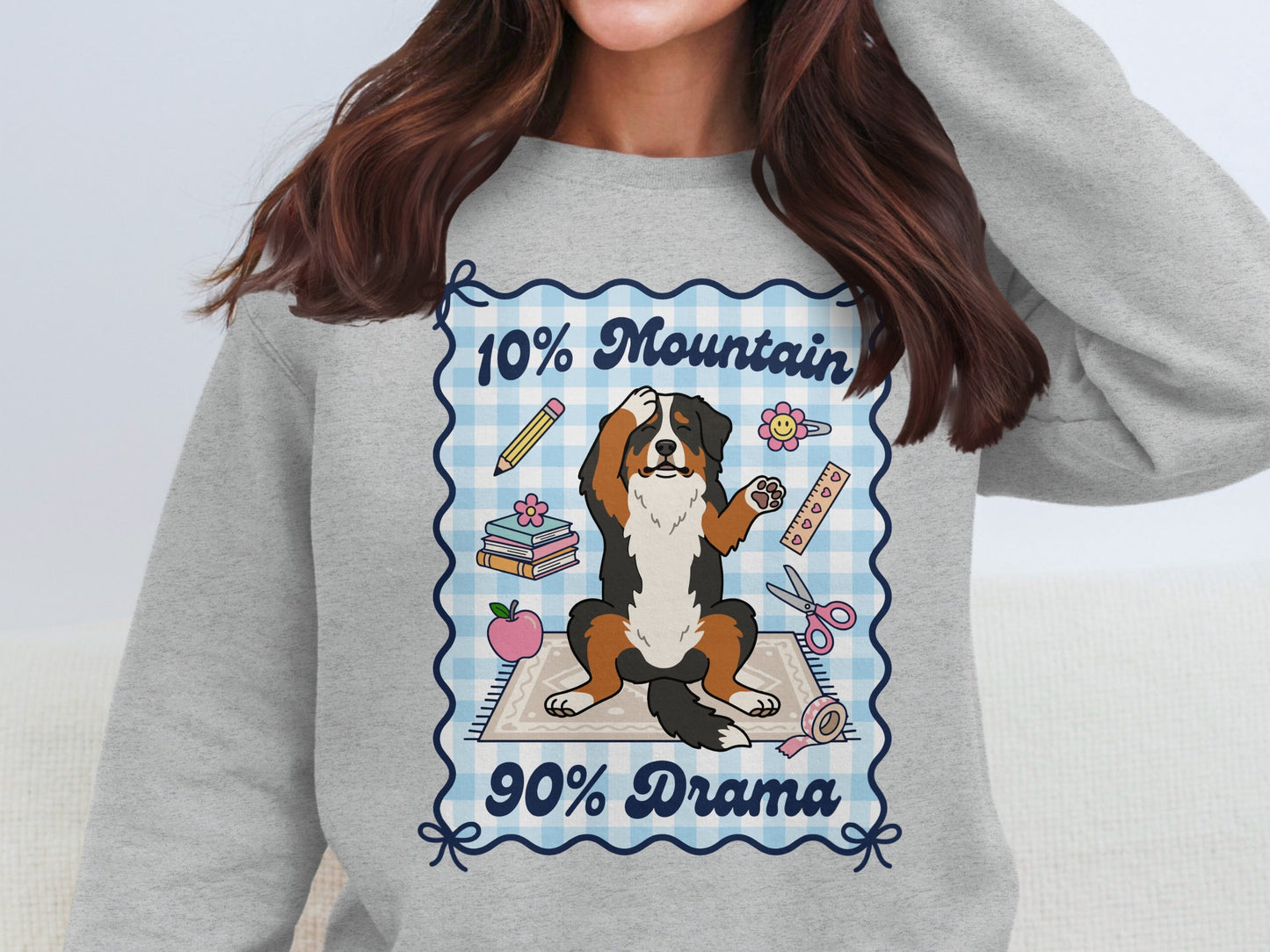 Bernese mountain dog with text "10% Mountain 90% Drama" surrounded by school supplies.