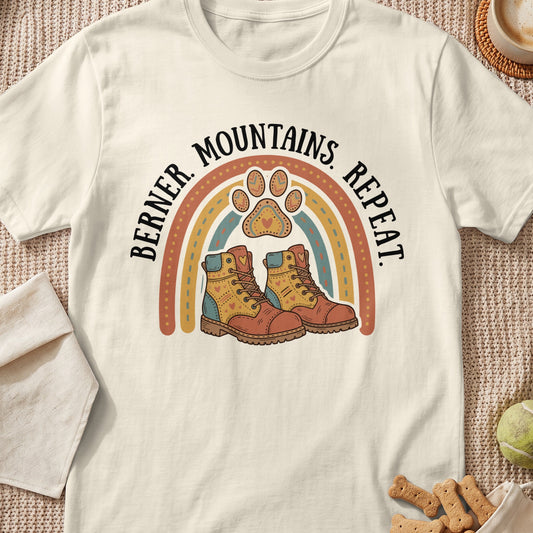 Berner Mountains Repeat text with rainbow, paw print, and hiking boots graphic.