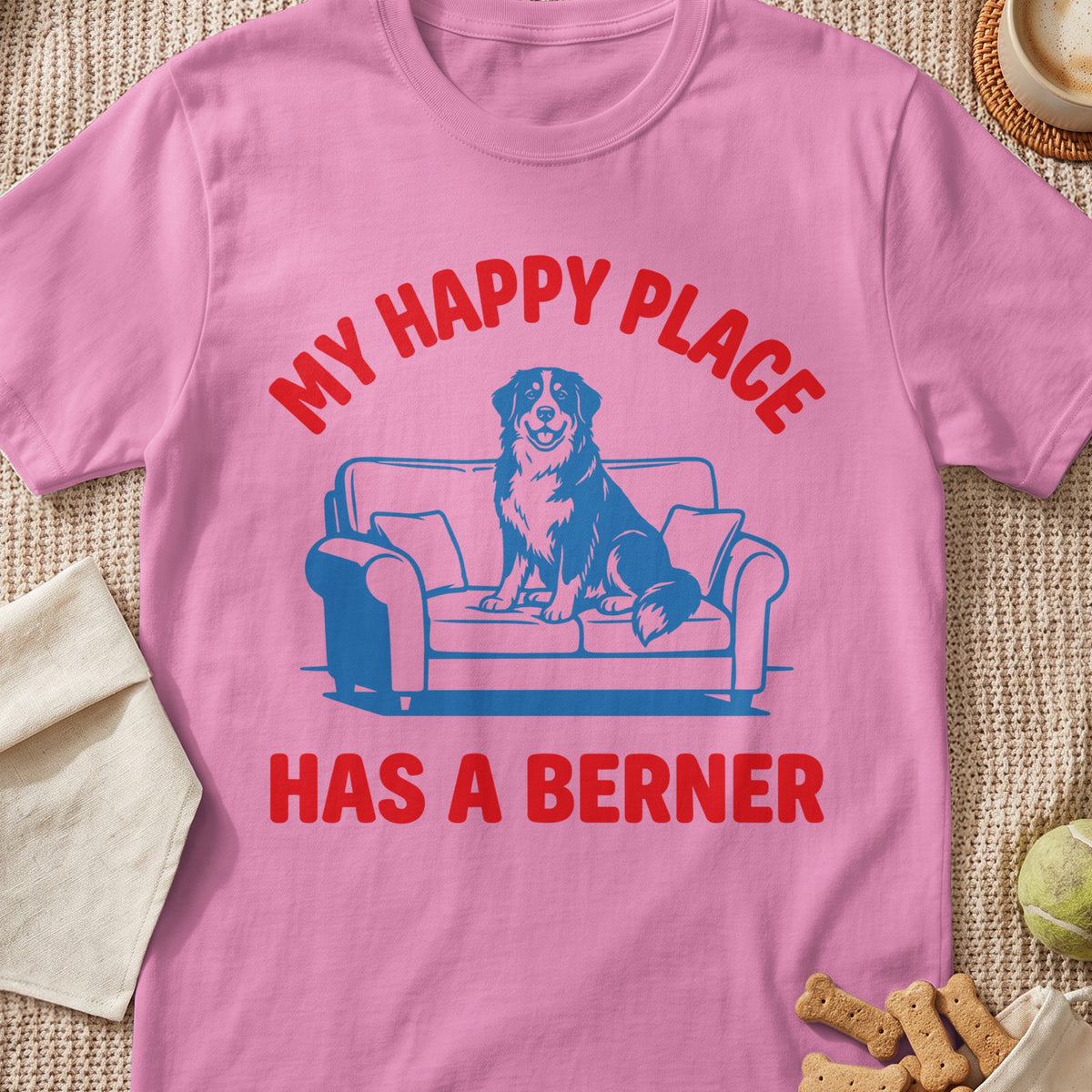 Pink t-shirt with "MY HAPPY PLACE HAS A BERNER" text and a dog on a couch graphic.
