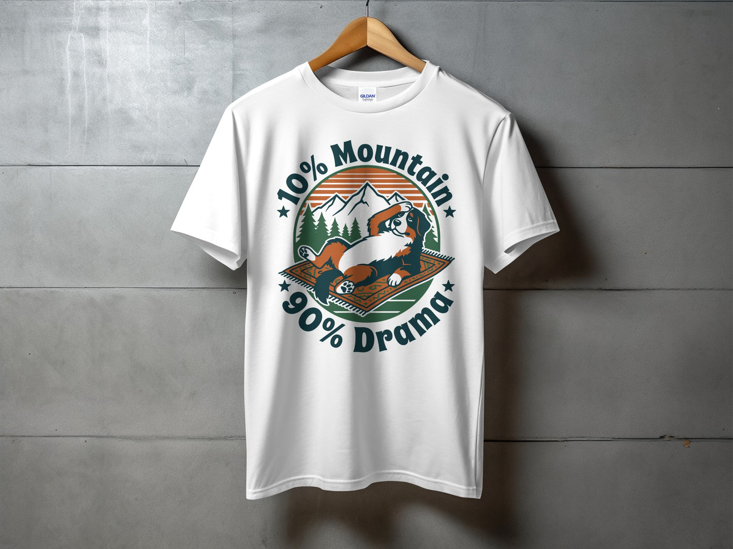 White t-shirt with graphic of dog on rug, mountains, and text "10% Mountain 90% Drama".