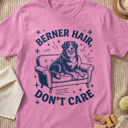 Pink t-shirt with navy graphic of a dog on a couch, text "BERNER HAIR, DON'T CARE".