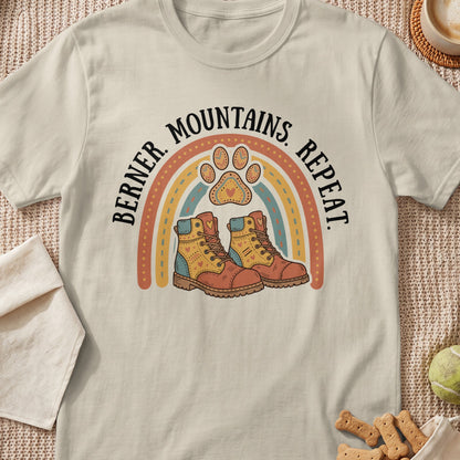 Bernese Mountains Repeat graphic with rainbow, paw print, and hiking boots.
