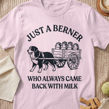 Pink t-shirt with black text and graphic of a dog pulling a cart of milk cans.