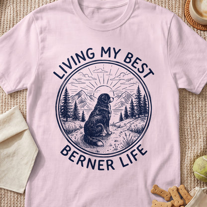 Berner dog sitting in a landscape with mountains and trees, text "Living My Best Berner Life".