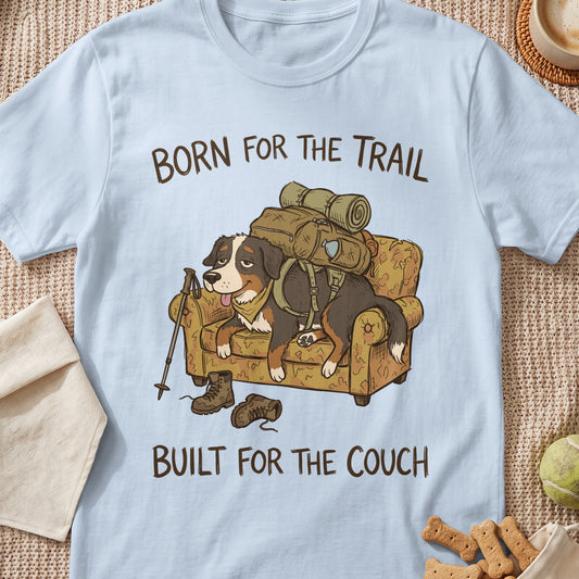 Bernese Mountain Dog on couch with backpack, text "BORN FOR THE TRAIL BUILT FOR THE COUCH".