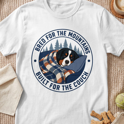 Bernese Mountain Dog wrapped in blanket with text "Bred for the Mountains, Built for the Couch."