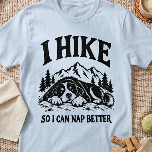 I Hike So I Can Nap Better t-shirt with sleeping dog and mountain graphic.