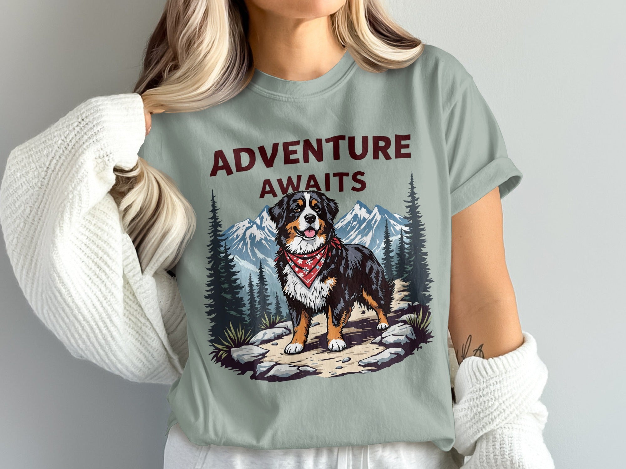 Bernese mountain dog with red bandana and mountains graphic: "ADVENTURE AWAITS"