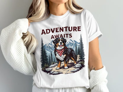 White t-shirt with "Adventure Awaits" graphic featuring a Bernese Mountain Dog in a forest scene.
