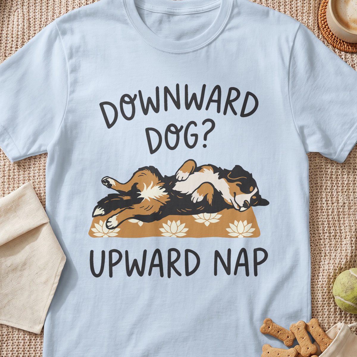 Light blue t-shirt with a dog lying on its back with text "DOWNWARD DOG? UPWARD NAP".