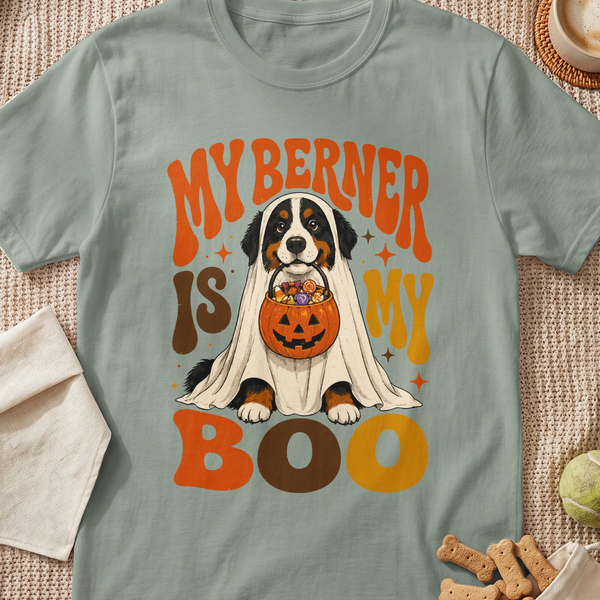 Bernese Mountain Dog in a ghost costume holds candy in a pumpkin bucket, text reads "My Berner is My Boo".