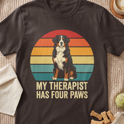 Bernese Mountain Dog sits in front of a retro sunset with text "My Therapist Has Four Paws".
