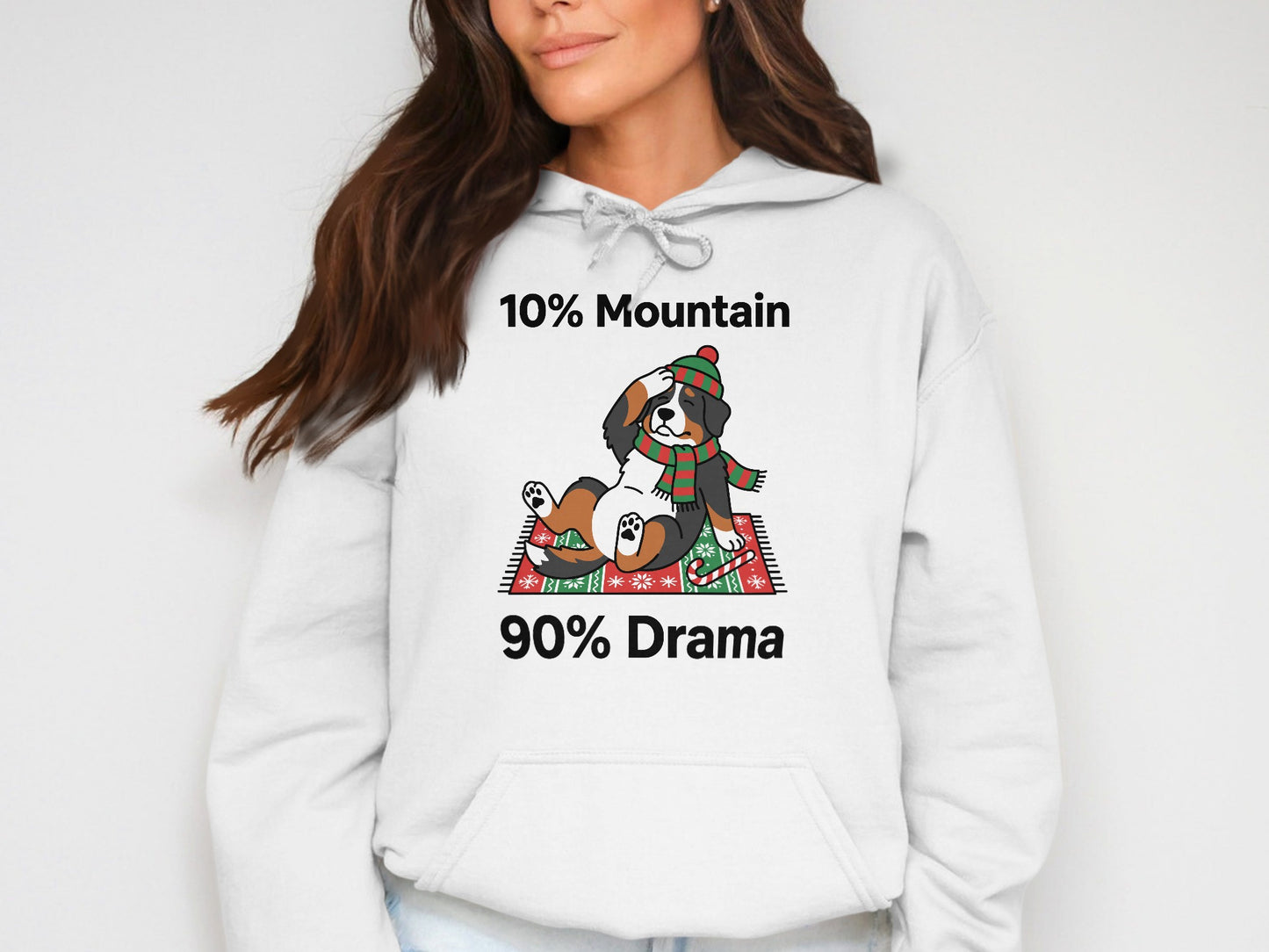 White hoodie with "10% Mountain 90% Drama" and cartoon dog in festive scarf.