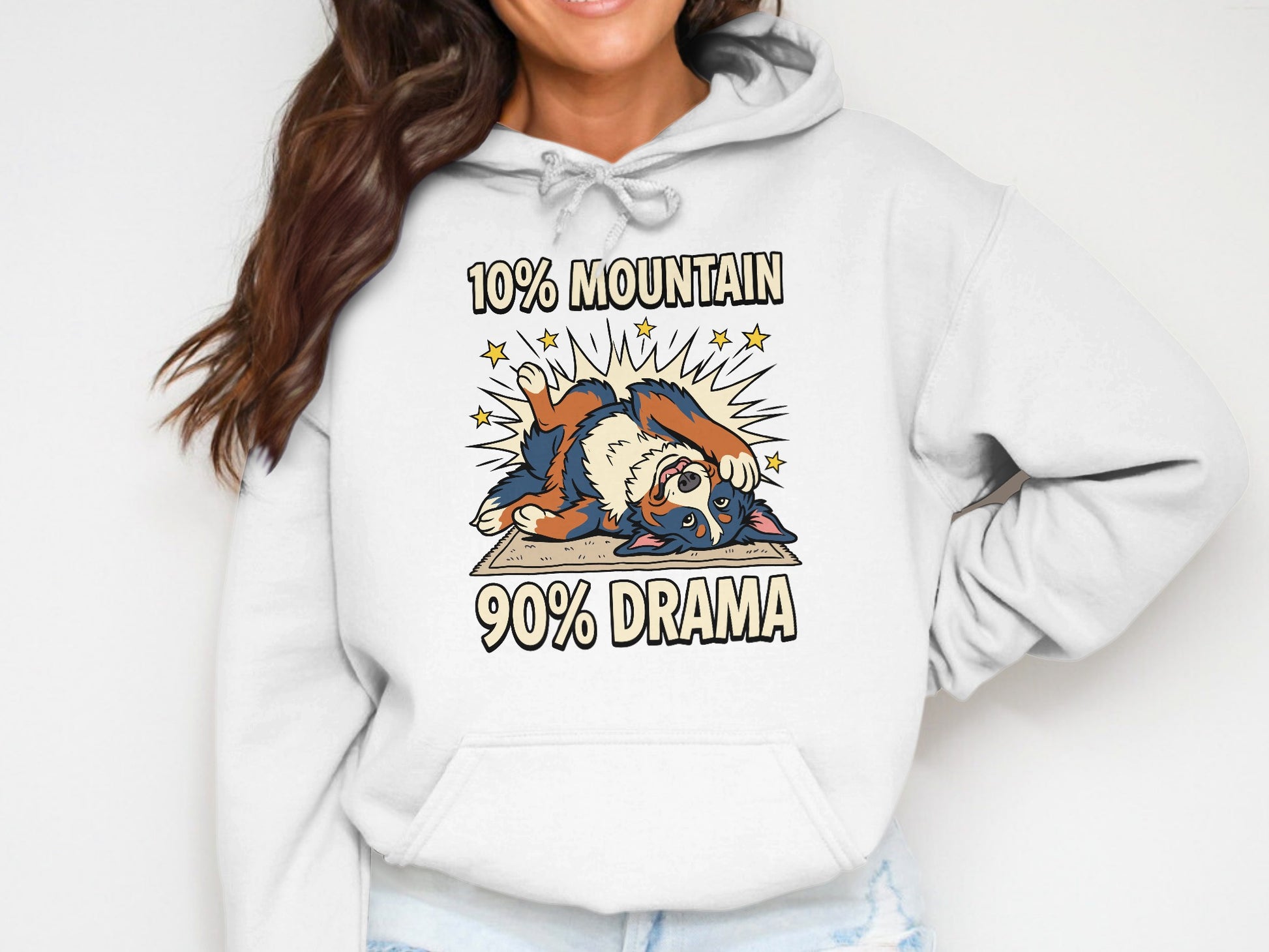 White hoodie with cartoon dog and text "10% Mountain 90% Drama."