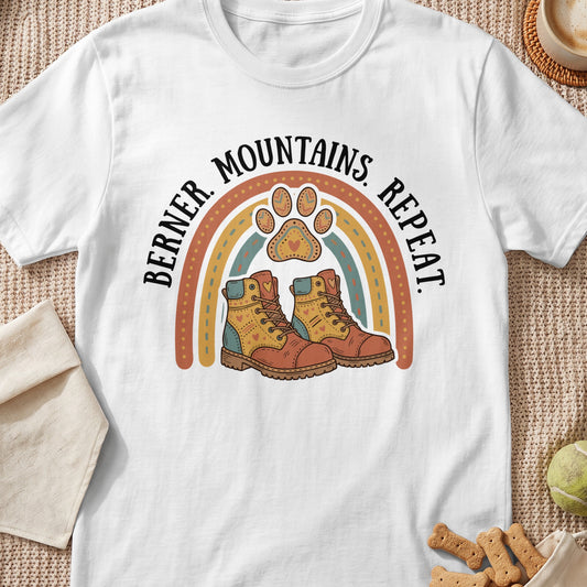 White t-shirt graphic with rainbow, boots, and paw print with text.