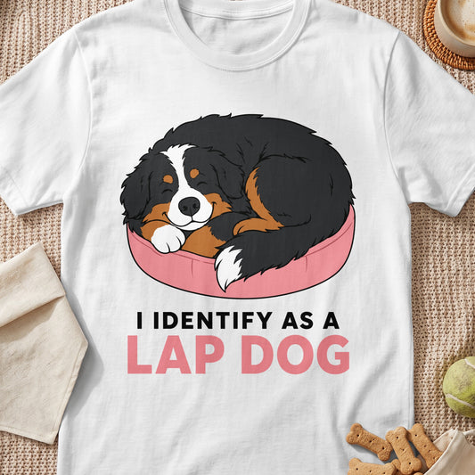 Bernese Mountain Dog sleeping on pink bed with text "I IDENTIFY AS A LAP DOG".