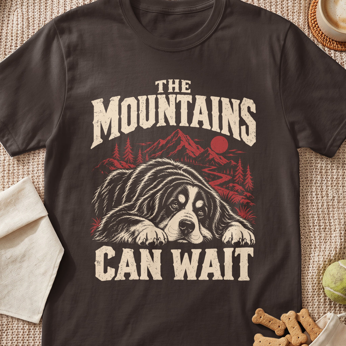 T-shirt with a dog and mountains graphic and text "The Mountains Can Wait".