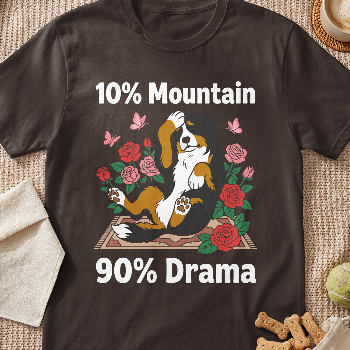 Bernese Mountain dog lying down with roses and butterflies, text "10% Mountain 90% Drama".