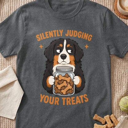 Bernese Mountain Dog holding jar of bone treats with text "SILENTLY JUDGING YOUR TREATS".