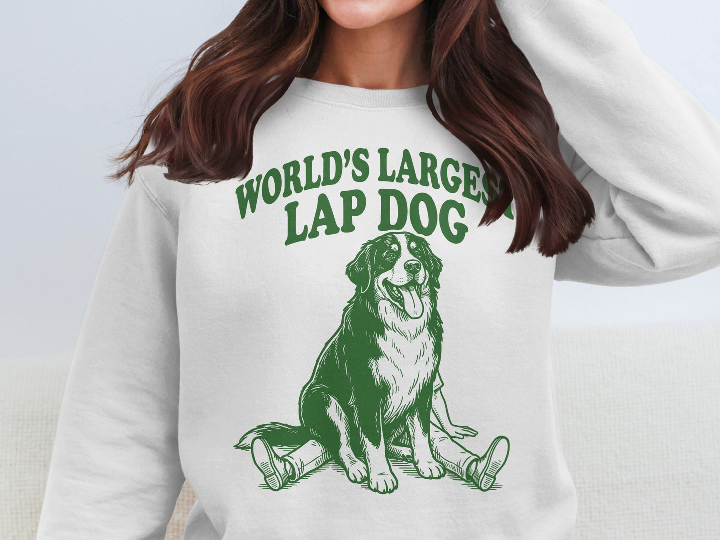 White sweatshirt with green graphic of large dog and text "World's Largest Lap Dog."