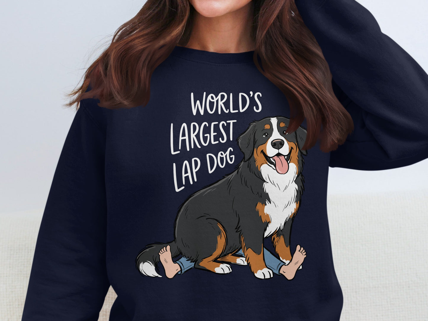 Bernese Mountain Dog design with text "WORLD'S LARGEST LAP DOG" on navy sweatshirt.