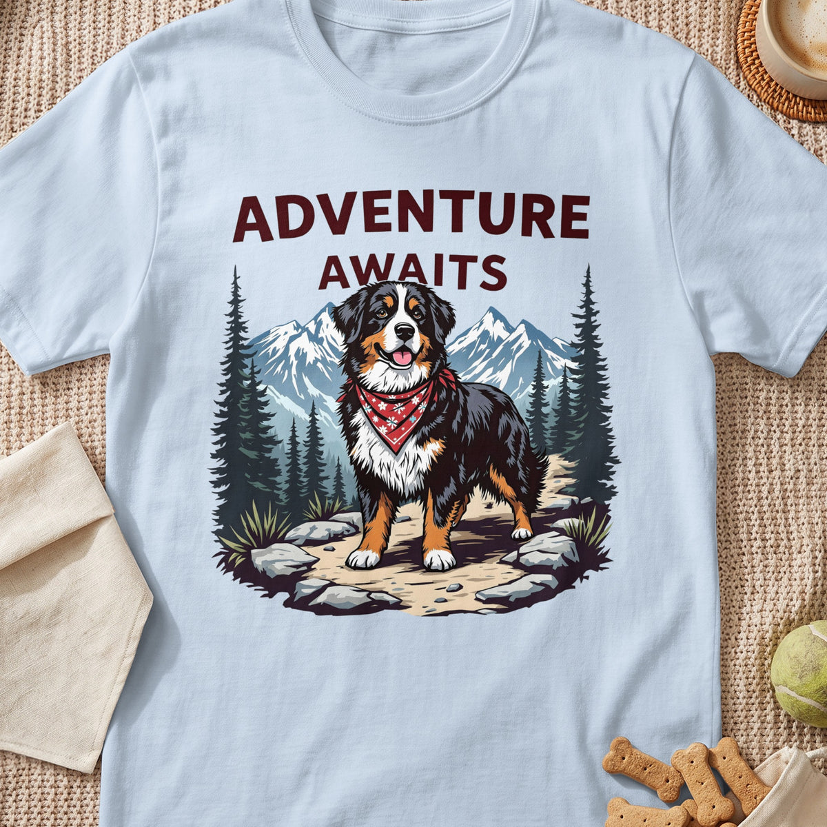 Bernese Mountain Dog with bandana, mountains, trees, and text "ADVENTURE WAITS".