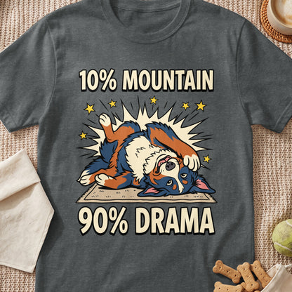 A dark gray t-shirt featuring a cartoon Bernese Mountain Dog lying on its back with the text 10% mountain 90% drama.