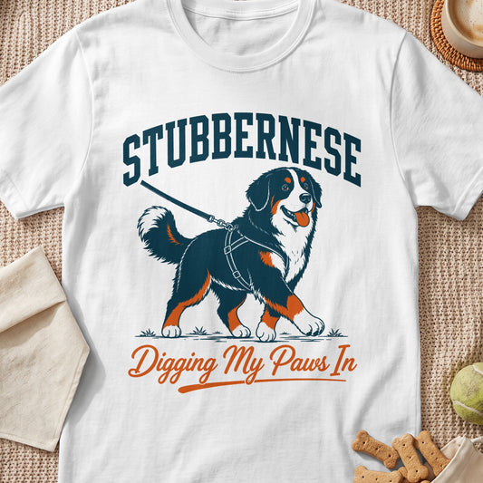 Bernese Mountain Dog wearing harness, text "STUBBERNESE Digging My Paws In".