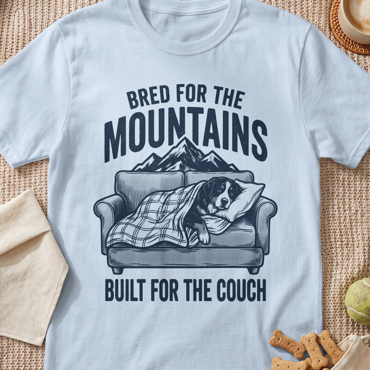 Bernese Mountain Dog sleeping on couch with text "Bred for the Mountains, Built for the Couch".