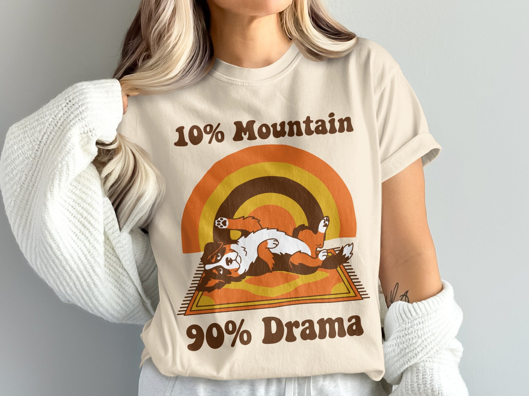 Cream t-shirt with brown text 10% Mountain and 90% Drama, and a dog graphic.